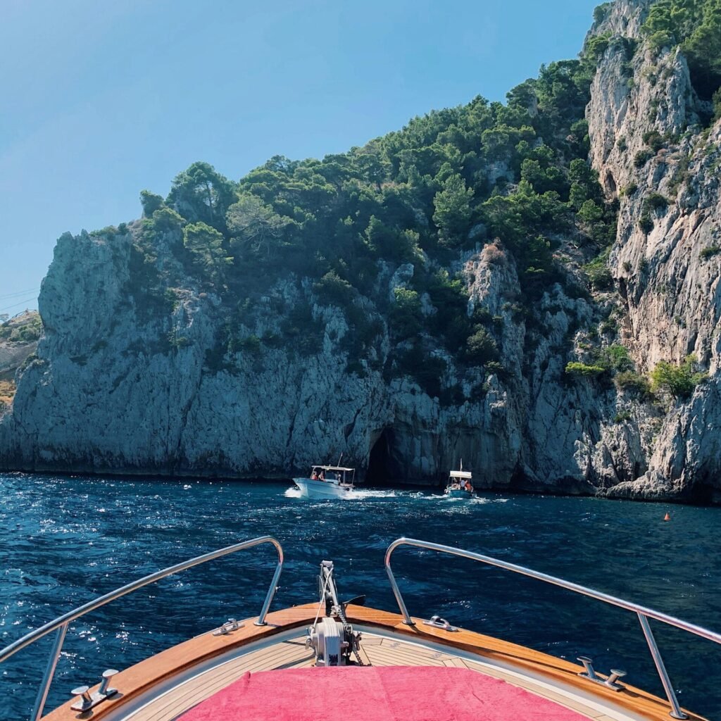 A scenic boat ride on the Amalfi Coast, showcasing majestic cliffs and the azure sea.